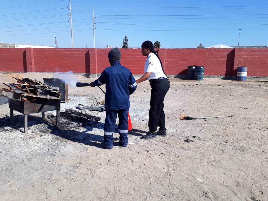 Instructor coaching trainee at live fire